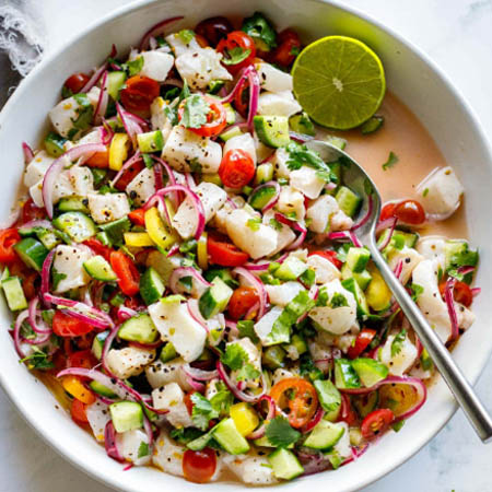 Ceviche recipe featuring diced fish and shrimp marinated in lime juice with cilantro and jalapeños.