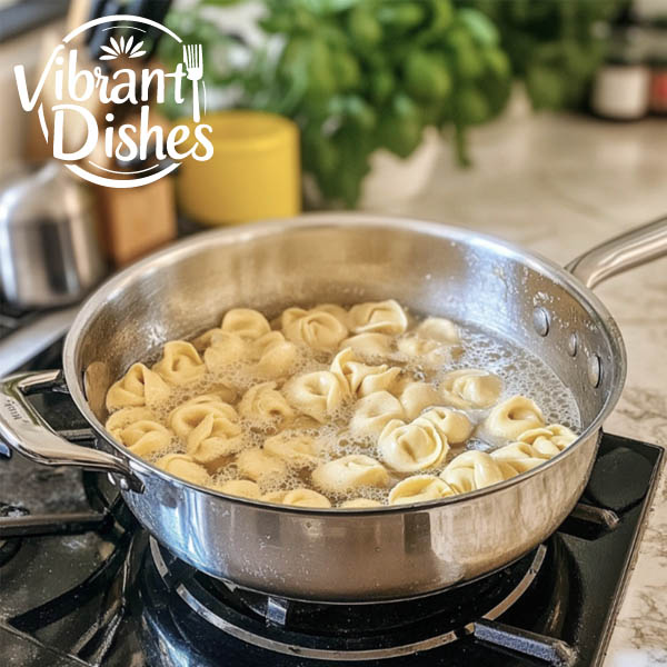 Tortellini cooking in boiling water with steam rising.