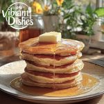 Fluffy golden pancakes with syrup and butter in a cozy setting.