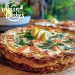 Golden salmon quiche with creamy custard and fresh dill on a rustic table.