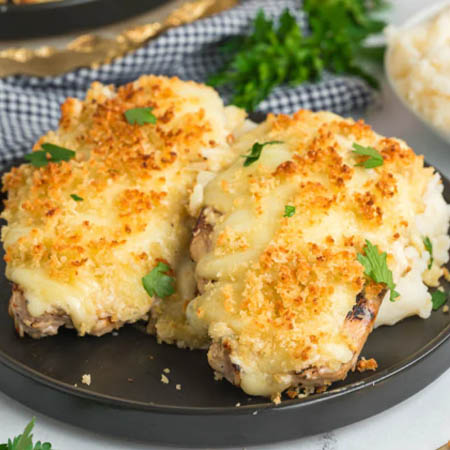 Parmesan crusted chicken recipe featuring golden, crispy topping on juicy chicken breasts.