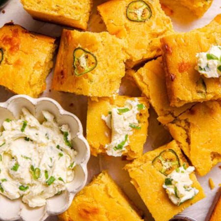 Mexican cornbread Jiffy recipe featuring moist cornbread with jalapeños, cheese, and corn in a cast-iron skillet.