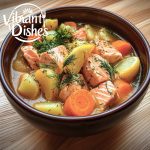 Salmon stew in a ceramic bowl with vegetables and dill.